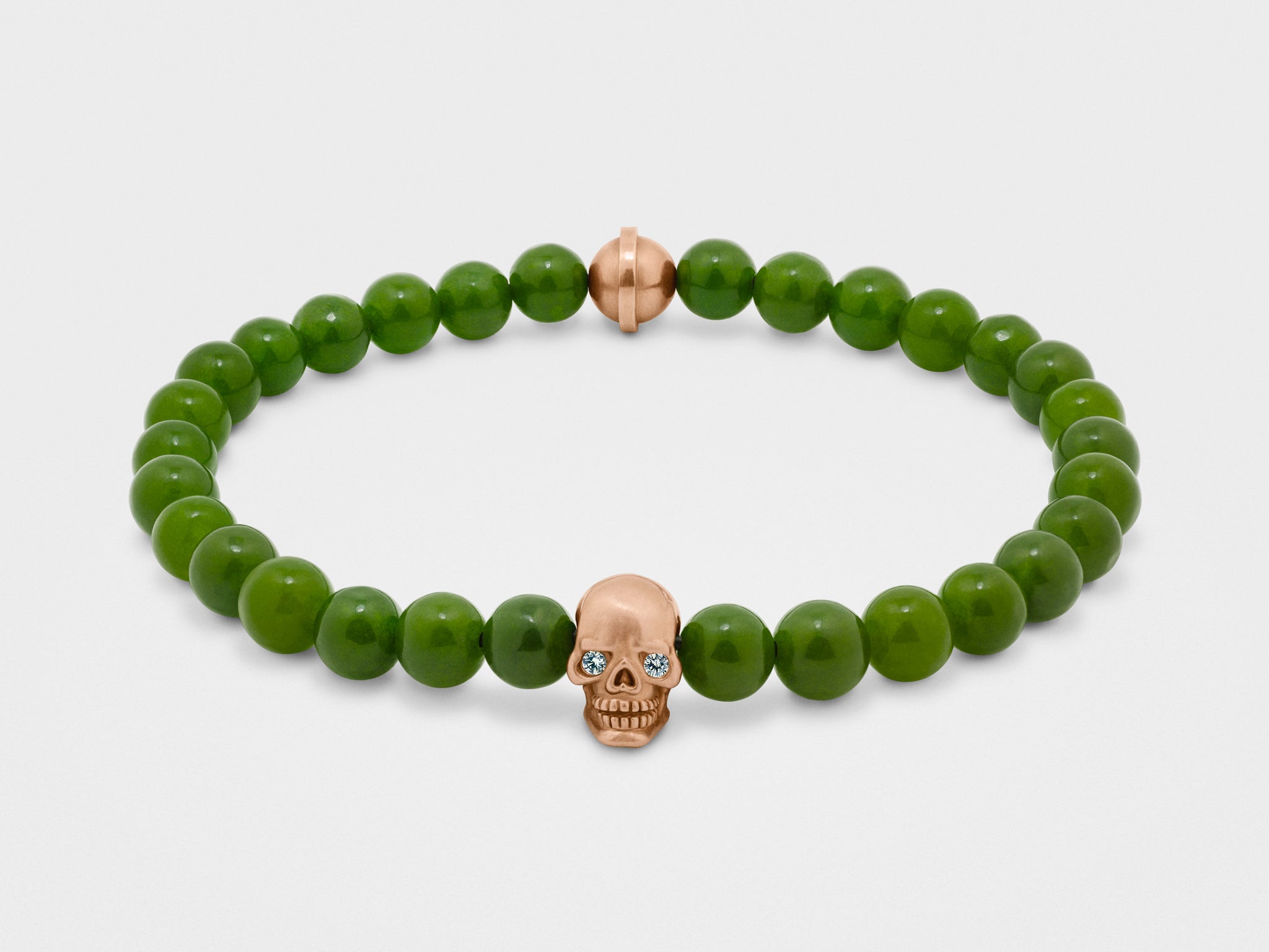 Skull Bracelet in Gold with Clear Eyes and Green Bead