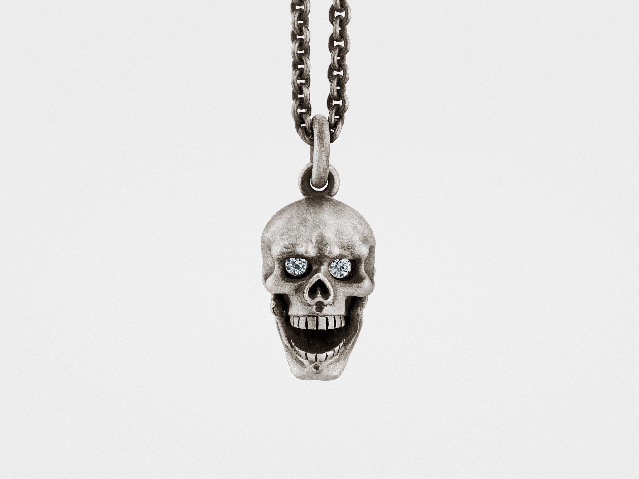 Skull Pendant with Hinged Jaw and Clear Eyes in Silver